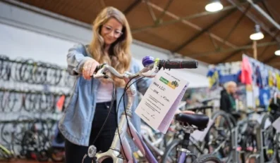 A woman looking at a bike in a store